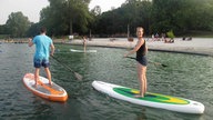 Zwei Stehpaddler auf einem See bei Köln