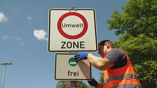 Foto: Arbeiter tauscht Umweltzonenschild aus